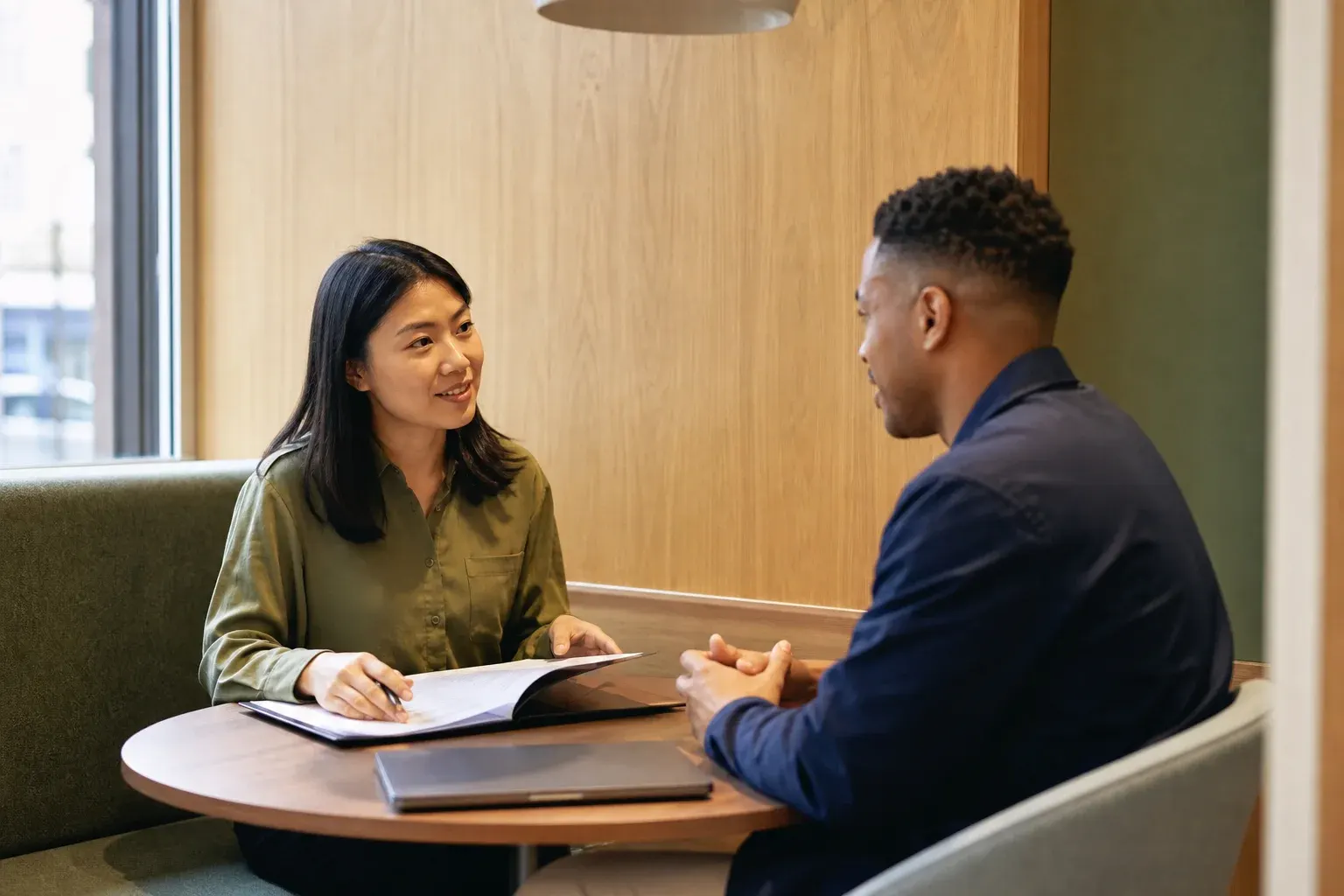 HR generalist discussing onboarding documents with a new employee