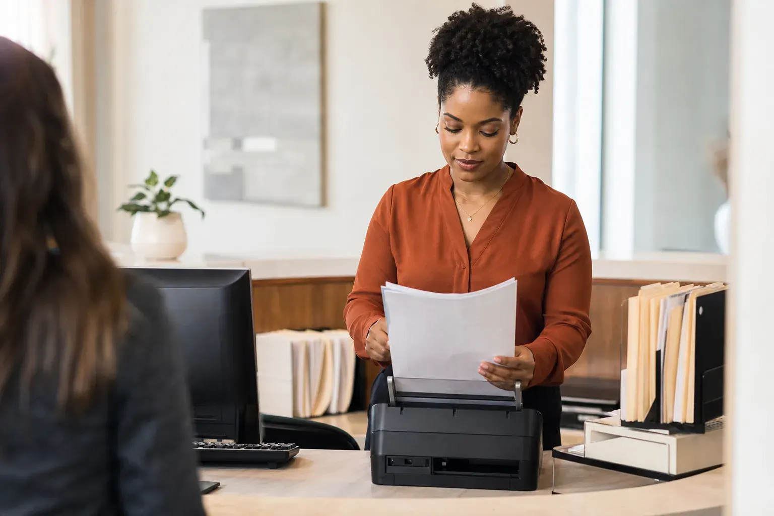 Paralegal scanning incoming case documents at a law firm