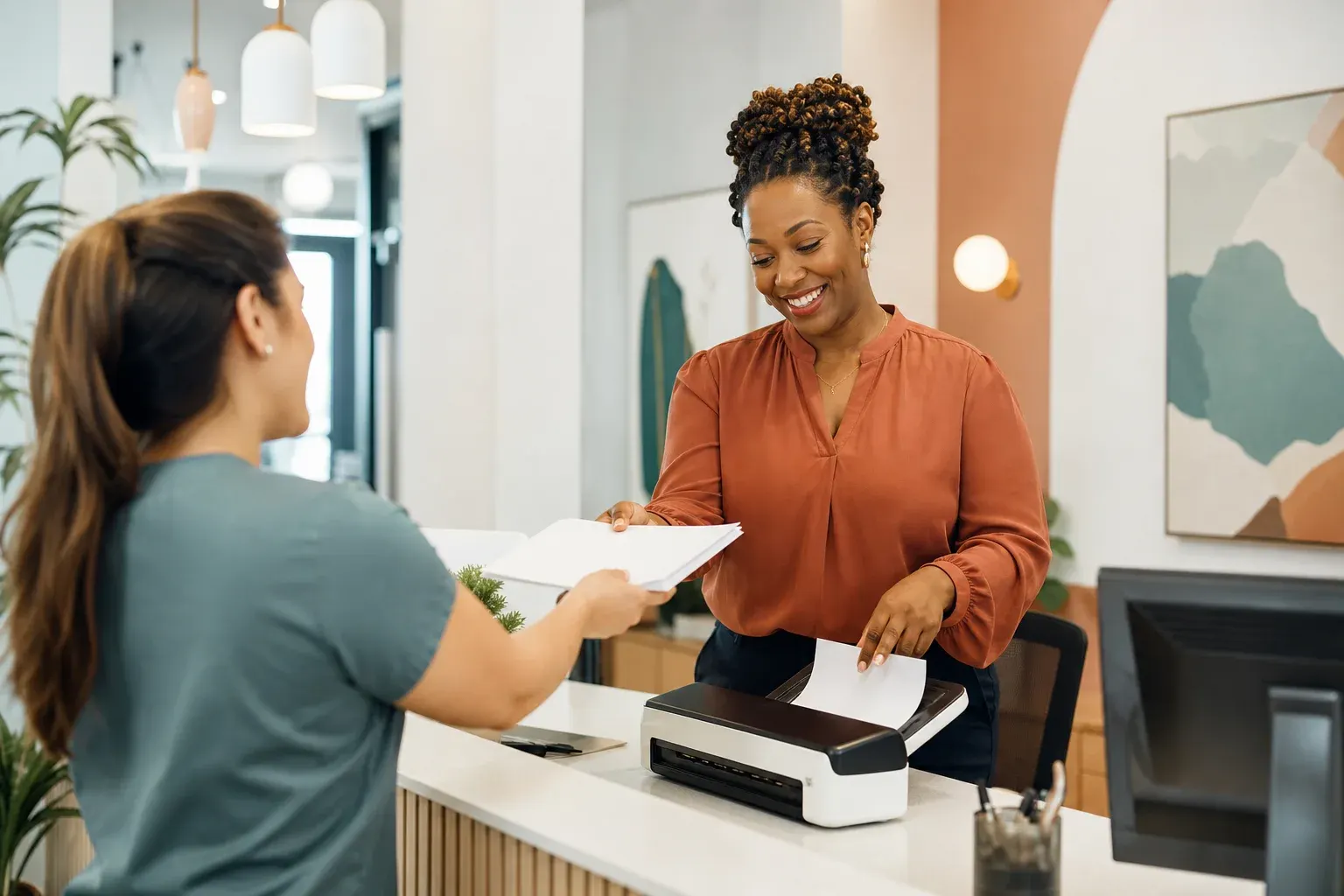 Practice manager scanning intake documents at a medical front desk